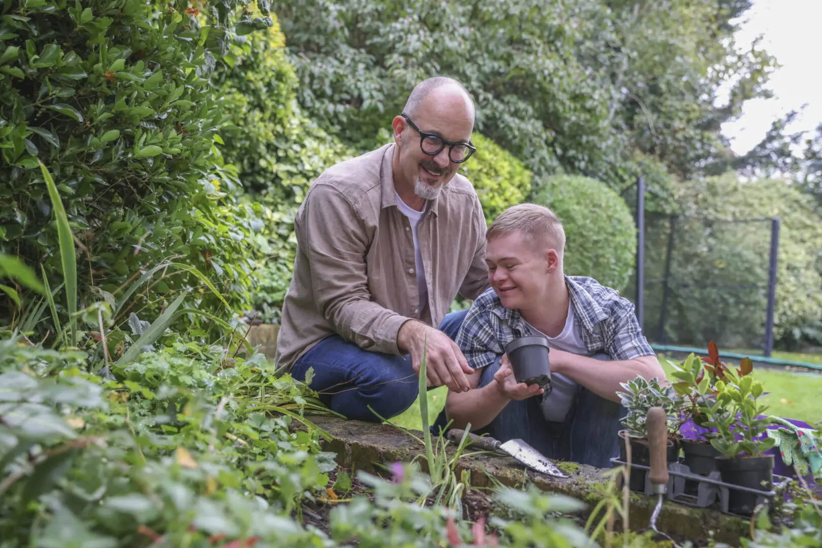 Two men enjoying gardening together outdoors.